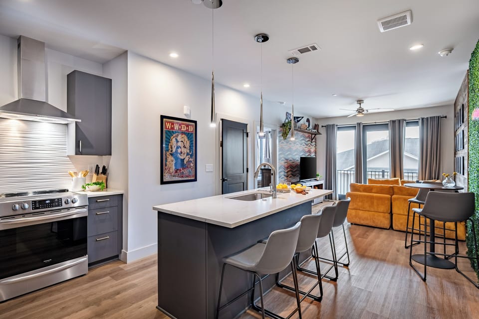 Open-concept kitchen and living area with an island seating area.