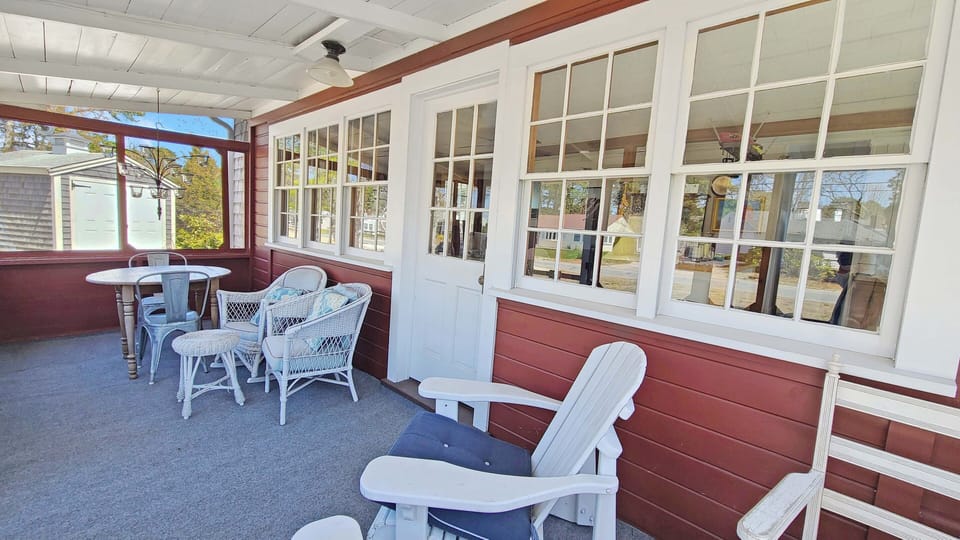 Front screen porch with table and seating