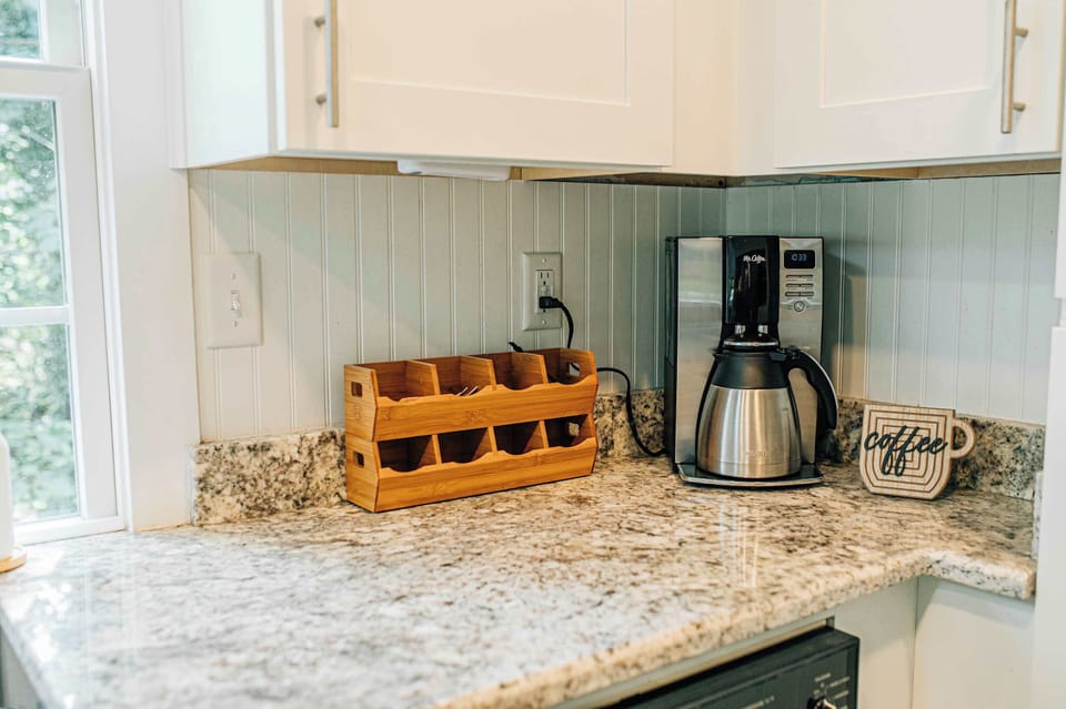 Drip coffee maker, assorted teas, coffee, decaf, and sugar are all tucked away in the coffee and tea bar—everything you need for a cozy cup.
