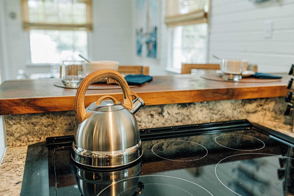 Start your mornings with tea or coffee in this charming kitchen, complete with a stylish kettle and breakfast bar perfect for planning the day ahead.
