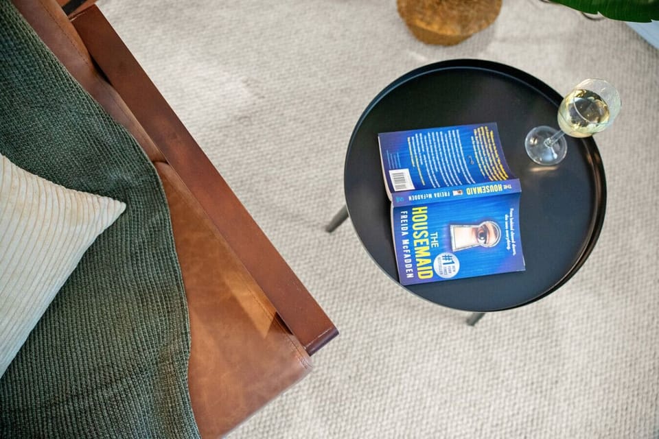 Book, blanket, and a glass of wine . Dive into your next page-turner in this peaceful corner—perfect for slow mornings, lazy afternoons, or winding down after a day of exploring.