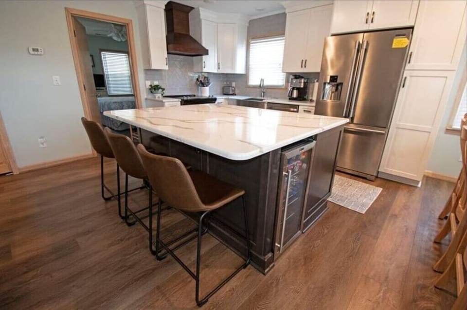 Fully stocked kitchen with island seating and drink fridge