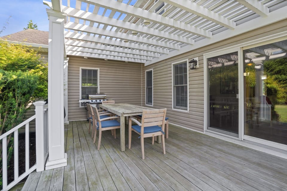 Pergola-covered dining deck with grill