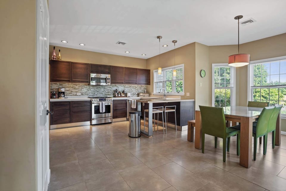 Bright kitchen with island and stainless appliances