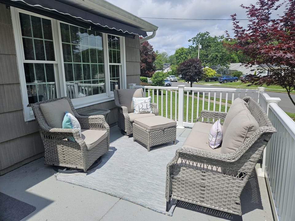 Front patio with comfortable seating and awning.