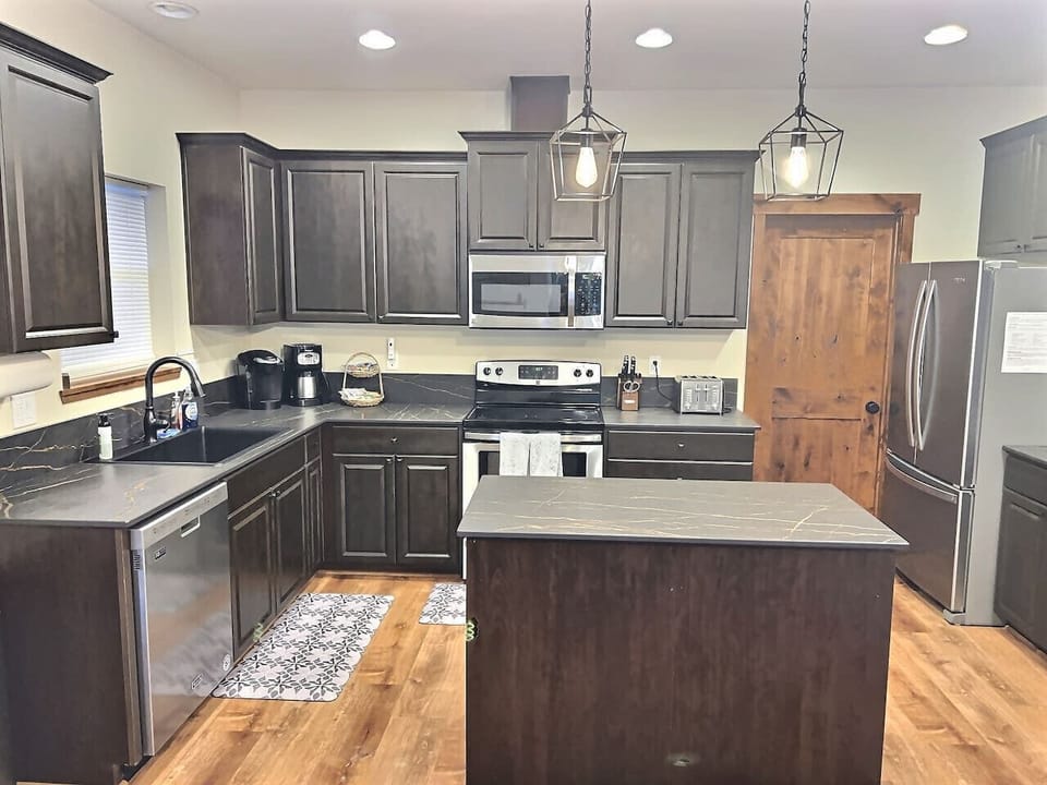 Fully stocked kitchen with a large central island and ample counter space for group cooking.
