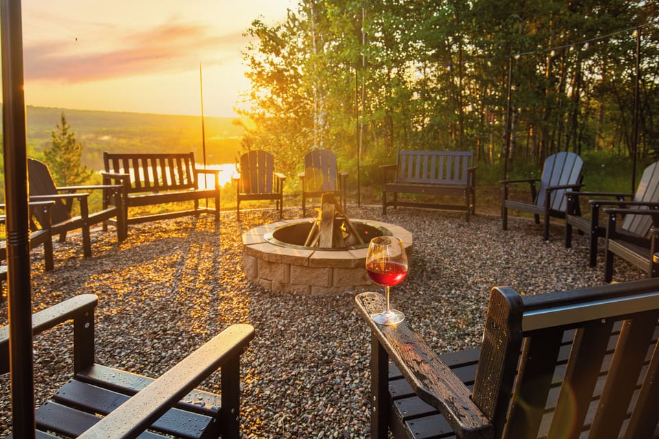 Late night laughs around a cozy fire pit with a glass of wine, friends, & family