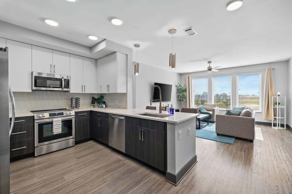 - Open shared  kitchen with stainless appliances and bright counters  
- Spacious layout connects smoothly to the living room  
- Ideal setup for longer stays and city travel convenience  