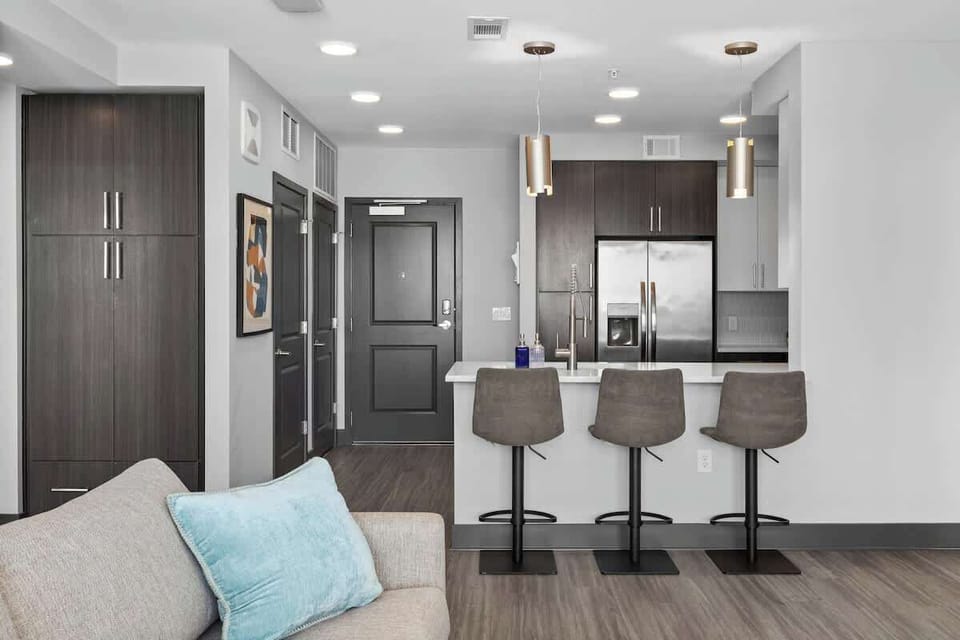 - Sleek shared  kitchen with stainless appliances perfect for extended stay cooking  
- Modern bar seating creates a social dining space  
- Open floor plan ideal for business travel and city getaways