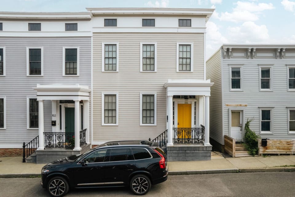 Classic facade with bold charm and a bright yellow door.