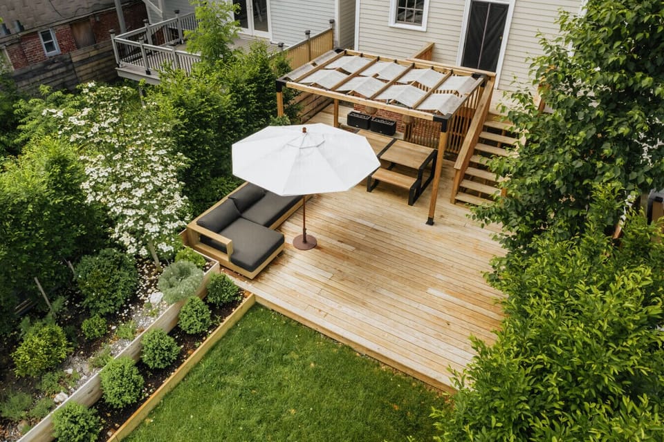 Spacious deck with seating and shade for outdoor lounging.