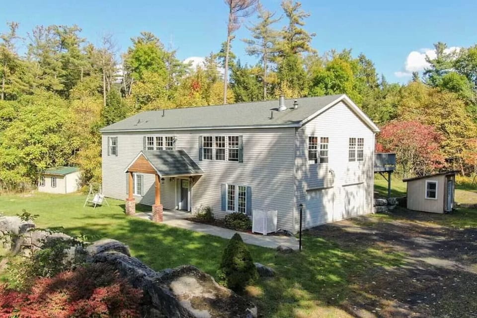 Exterior view of home with wooded backdrop