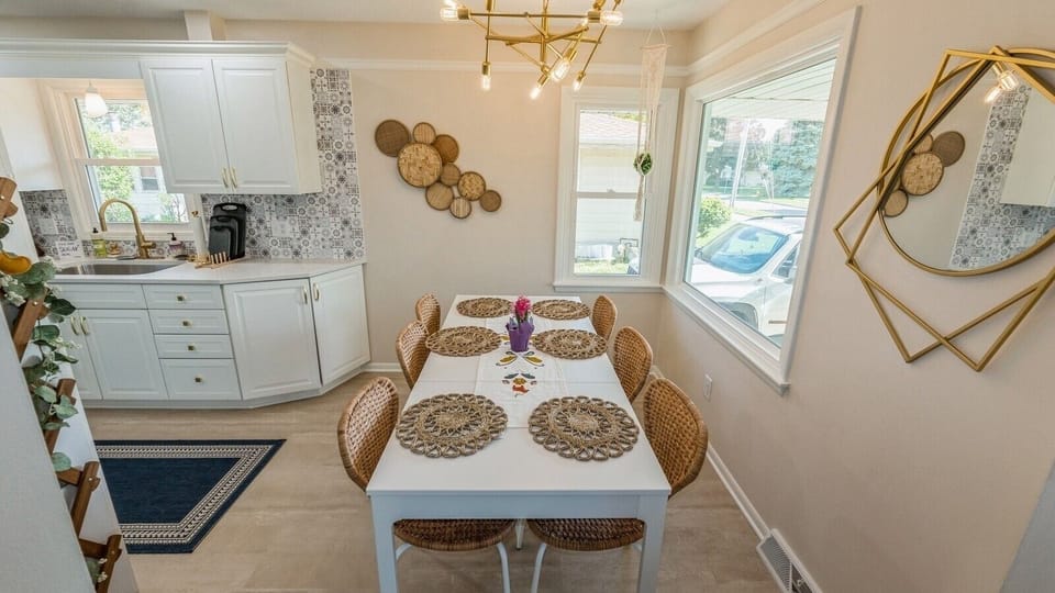 Bright dining area beside updated kitchen with seating for six.