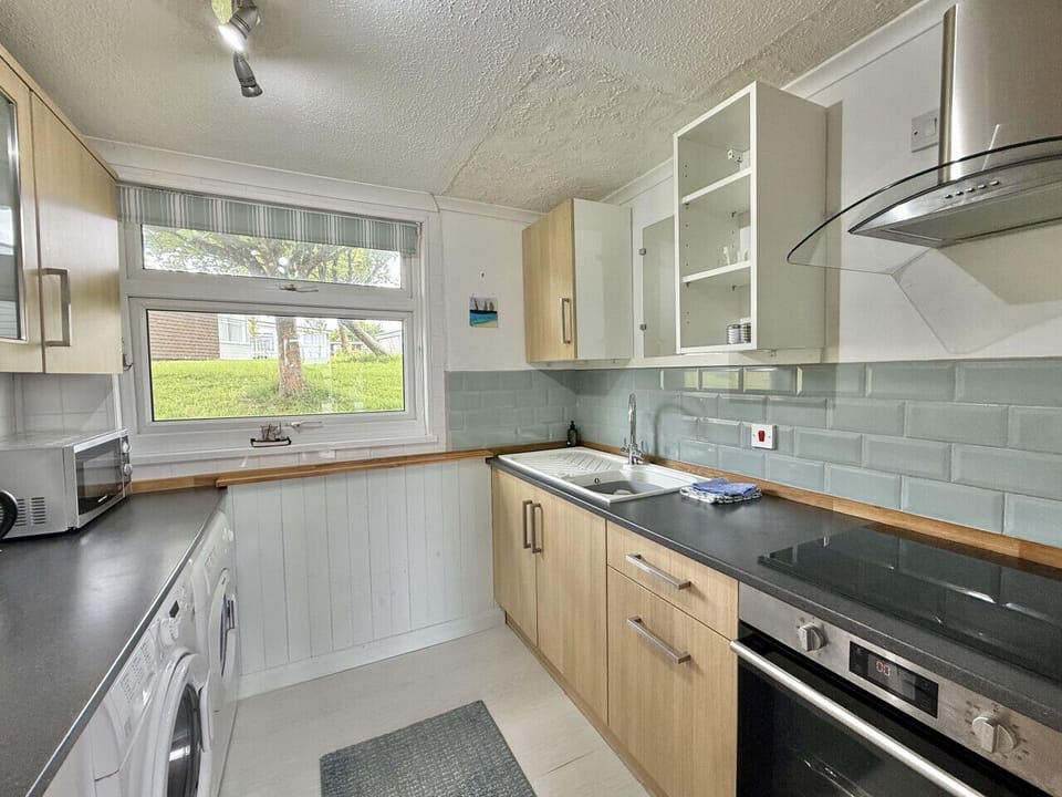 Well equipped galley kitchen with washing machine and tumble dryer