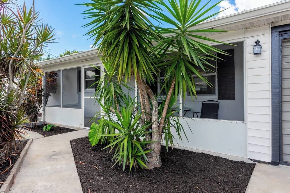 Front of property with screened porch and seating for 2