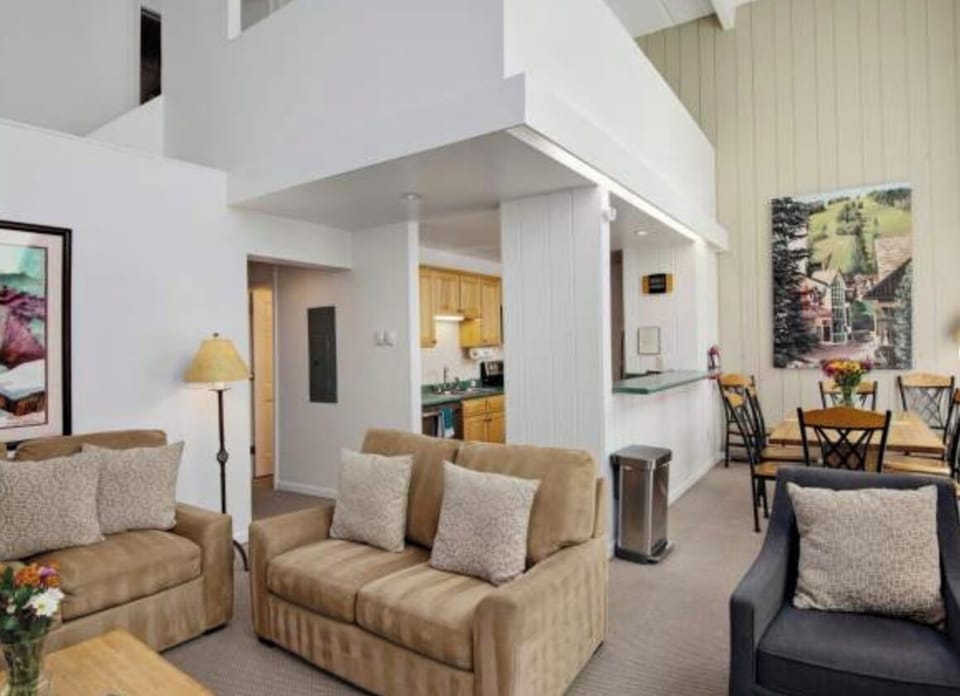 View of Living room from Fire Place can see kitchen and Loft above kitchen