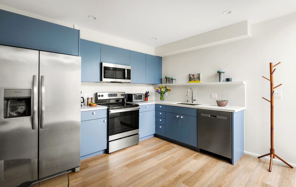 Clean lines, bold color, and fresh flowers bring this contemporary kitchen to life.
