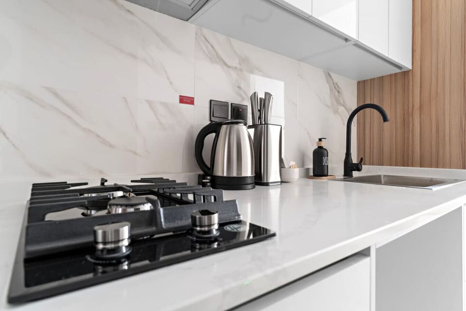 Kitchen: Sleek surfaces and modern appliances invite culinary adventures in style!