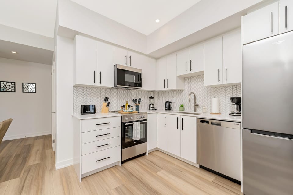 Modern Kitchen Featuring Stainless Steel Appliances And Ample Storage