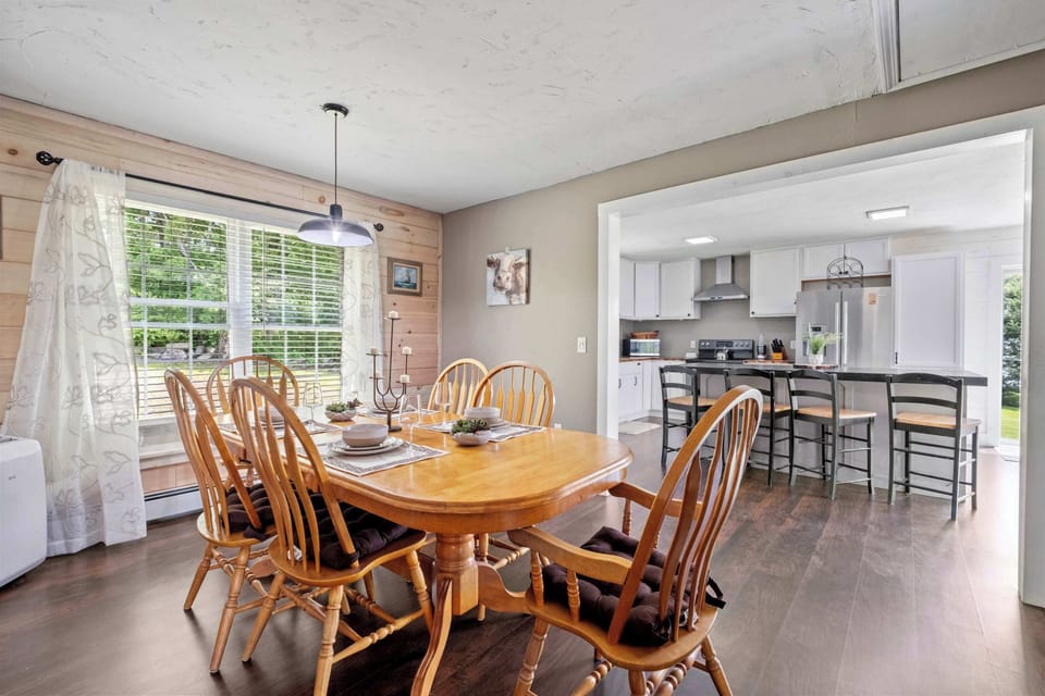 Gather around for meals and memories in this inviting dining space that opens directly into the kitchen—where the smell of coffee and good conversation fills the air.