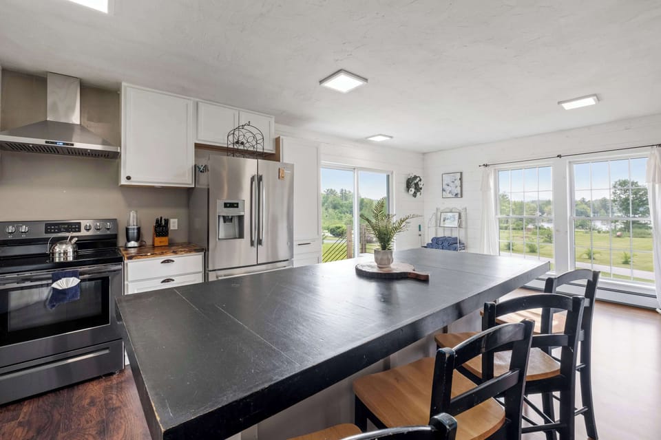 Wake up to wide-open views and sunshine pouring into this bright kitchen—perfect for morning coffee, pancake breakfasts, or afternoon snacks before your next lake adventure.
