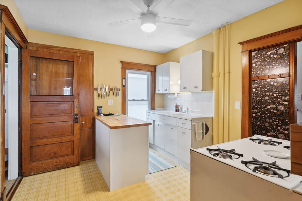 Your fully equipped kitchen awaits with modern appliances, ample counter space, and warm wood accents creating the perfect space for home-cooked meals.