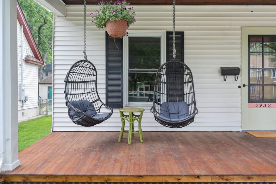 Swing into relaxation on your private porch with cozy hanging chairs and charming garden touches.