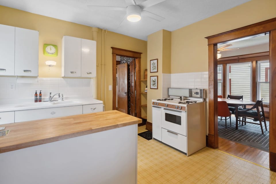 Your fully equipped kitchen features warm wood tones, modern appliances, and opens to a cozy dining nook perfect for home-cooked meals.