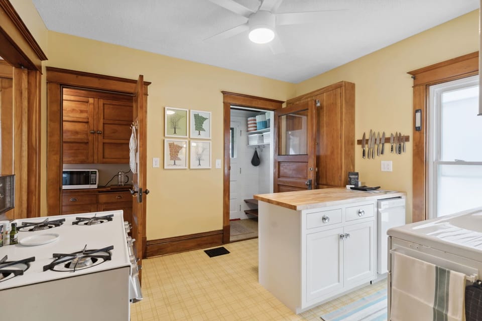 Cook your favorite meals in this warm, well-equipped kitchen with rich wood cabinetry and modern appliances for your comfort.