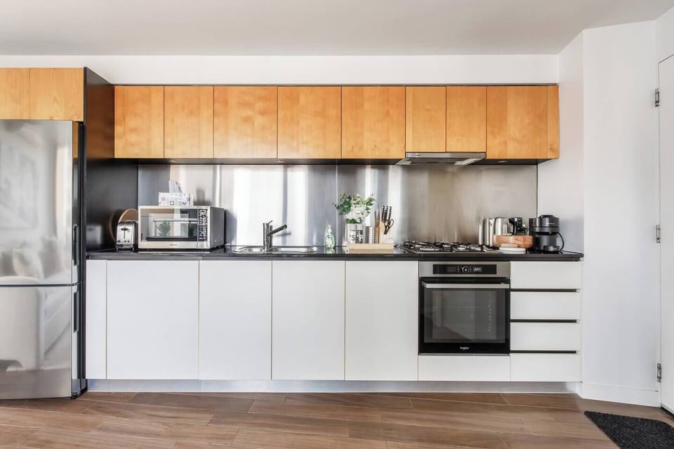 Cook up light bites in the sleek, snug kitchen, complete with modern appliances and thoughtful touches like coffee and wine glasses.