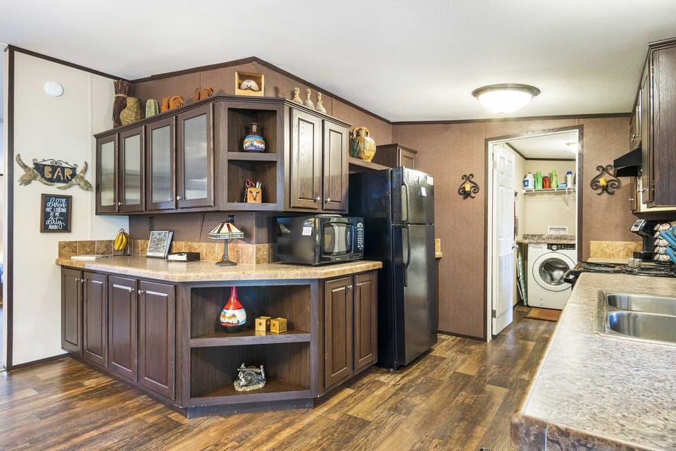 Charming kitchen with full appliances, rustic decor, and convenient access to the laundry room for a hassle-free stay.