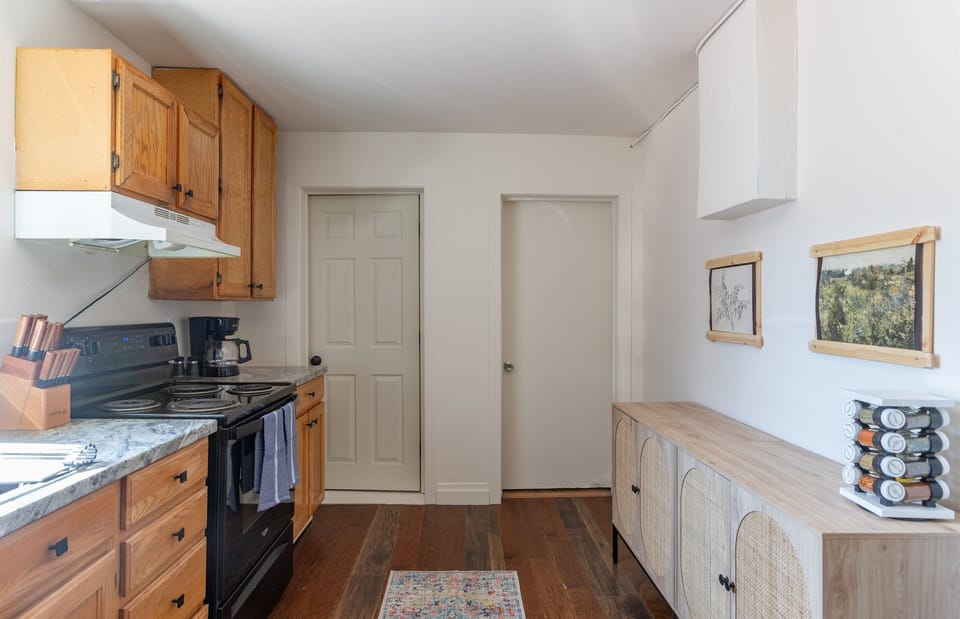 A kitchen with a stylish hutch and plenty of character