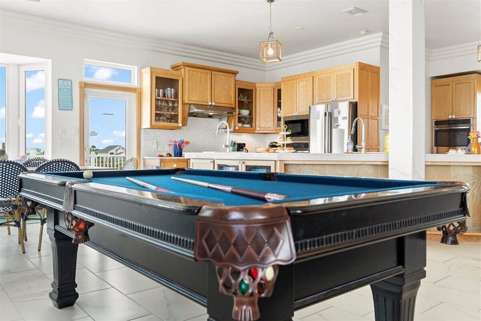 Chalk up and unwind with a friendly game of billiards, in the open-concept main level living space!