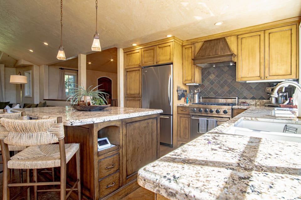 Well appointed kitchen with Granite Countertops and an island for prep.