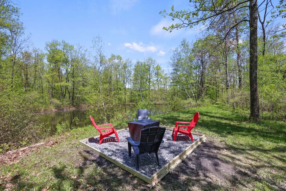 Our cozy firepit area with red patio chairs is the perfect place for s’mores, stargazing, or sipping wine after sunset.