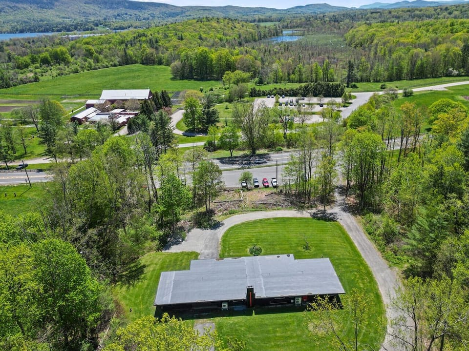 Surrounded by forest on all sides, this aerial view shows off the complete seclusion and large circular driveway