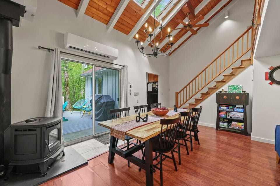 Dine in comfort next to the wood-burning stove and a feature brick wall stocked with games and books.