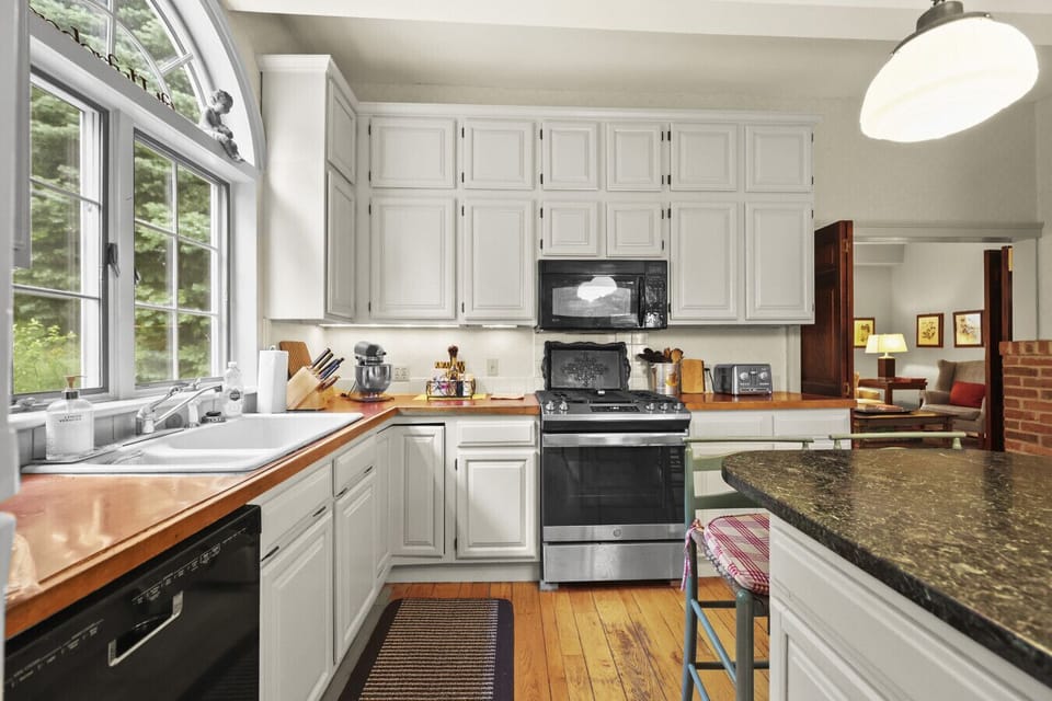 Large kitchen window bringing in natural light over cooking space.
