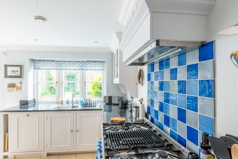 Ground floor: Kitchen with a window overlooking the rear courtyard garden