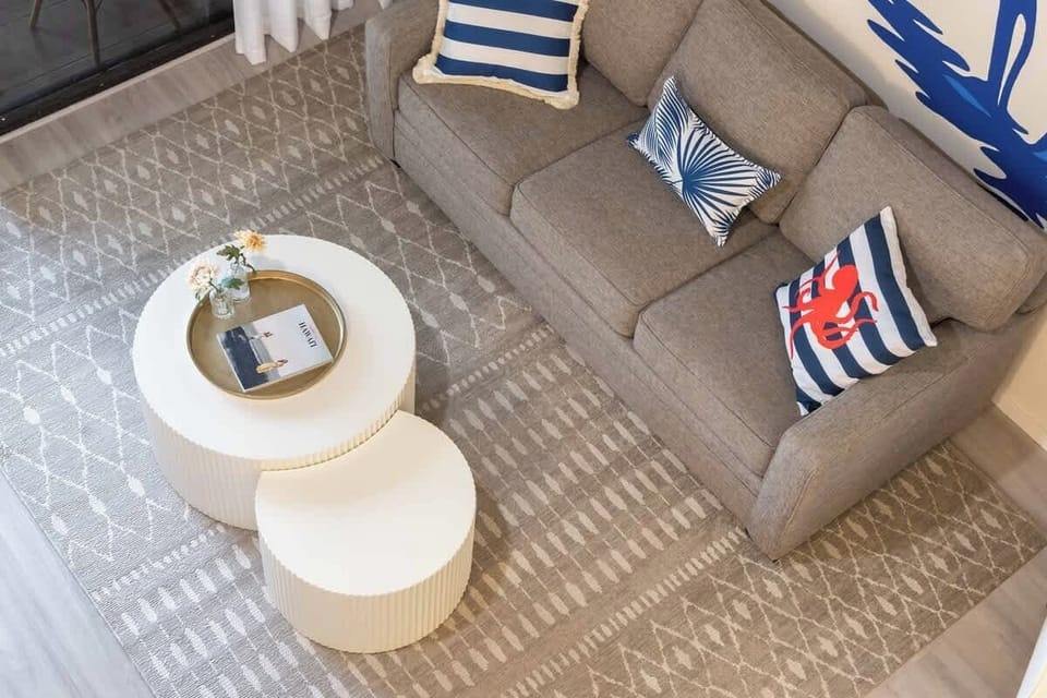 Cozy living area with nautical accents and modern nesting tables