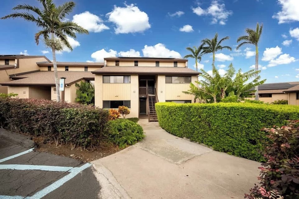 Tropical entryway with lush greenery and convenient parking