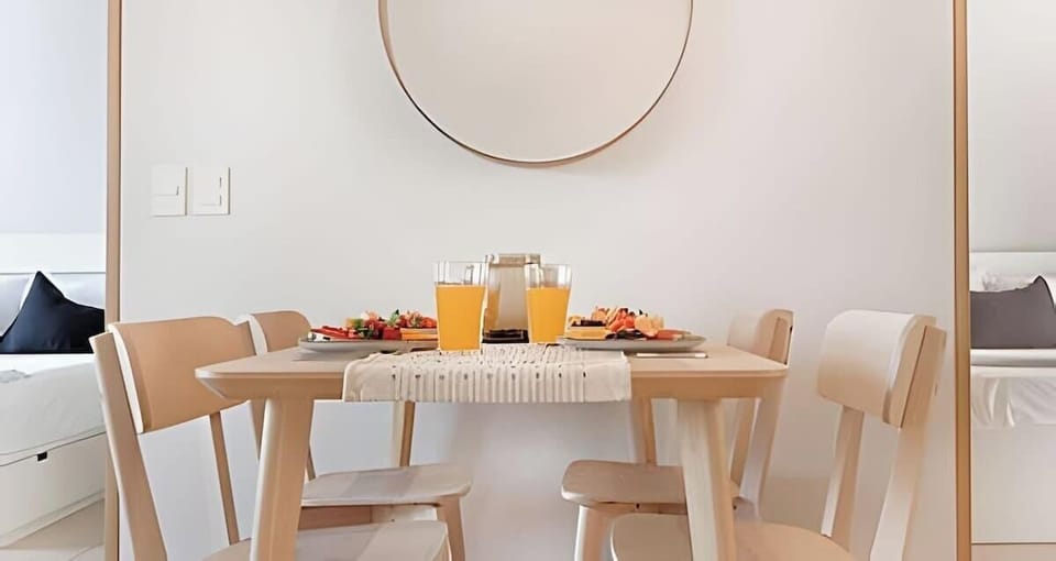 Bright dining corner w/ wood table, chairs & minimalist decor