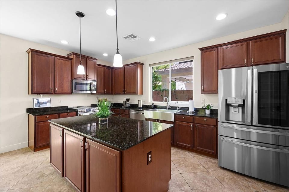 Kitchen island with granite counters and stainless-steel appliances