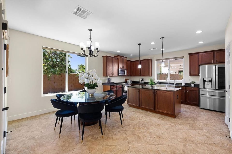 Eat-in kitchen with island, wood cabinets, dining table