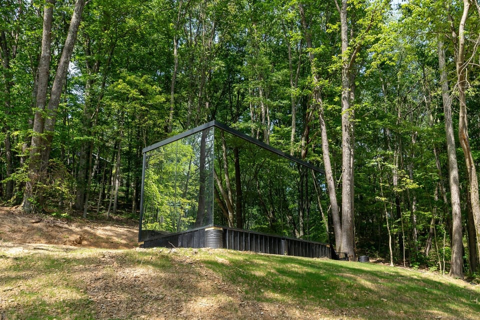 Surrounded by towering trees and total tranquility—this mirrored retreat offers couples a one-of-a-kind escape into the heart of the woods.