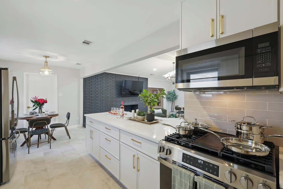 Grab a stool and enjoy a snack or drink at the breakfast bar. This sleek kitchen comes fully stocked and ready for anything.

