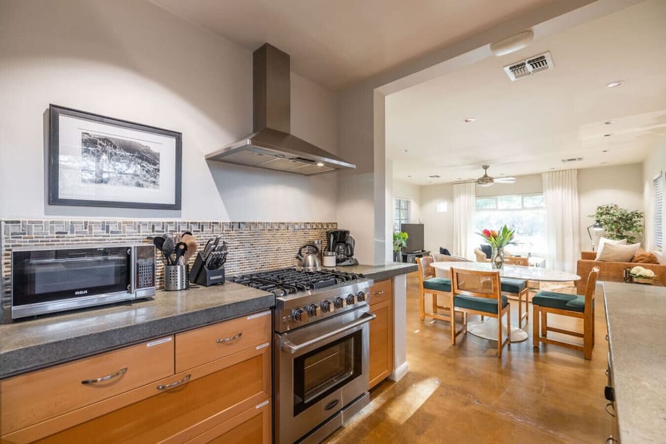 A clean, organized kitchen with ample cabinets and all the equipment you need for any meal.