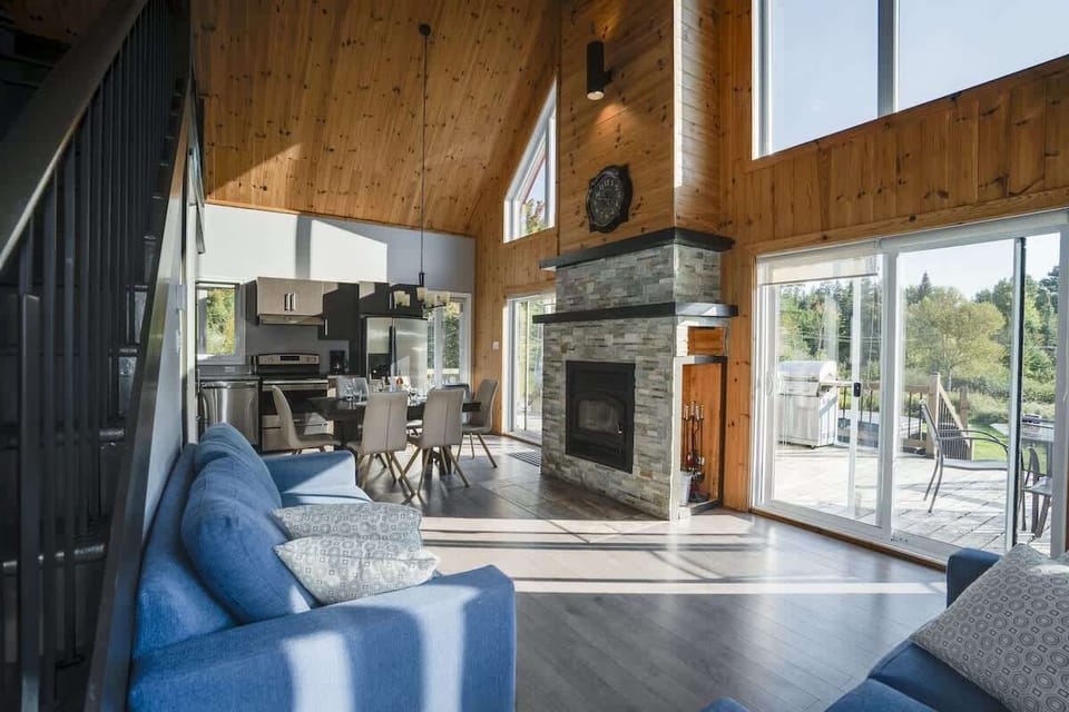Spacious interior with large windows, allowing natural light and mountain views.