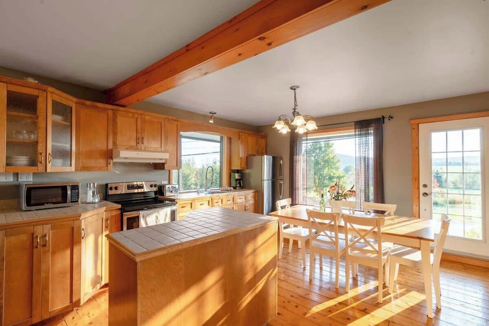 Dining area with large windows offering natural light and a great view of the surrounding landscape.