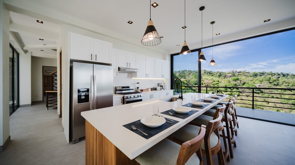 Stainless steel appliances, and a large island with seating make this kitchen both beautiful and functional.